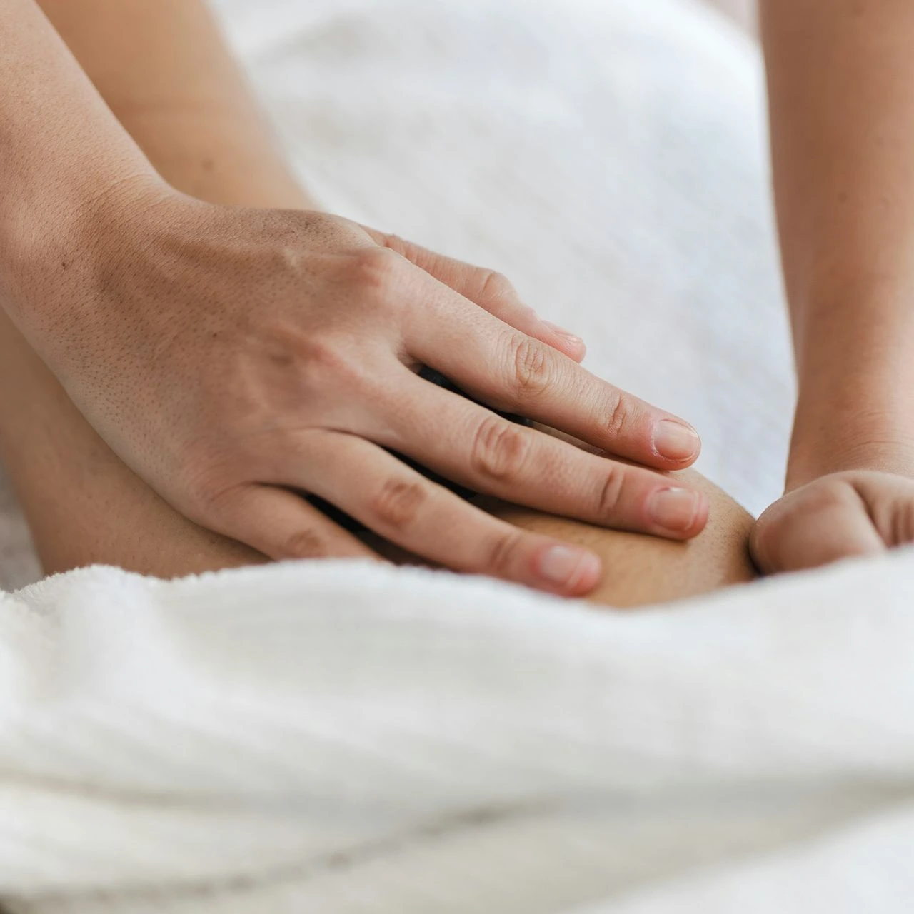 a close up of a person laying in a bed with a towel